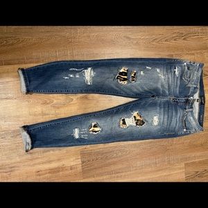 distressed jeans with leopard print detail